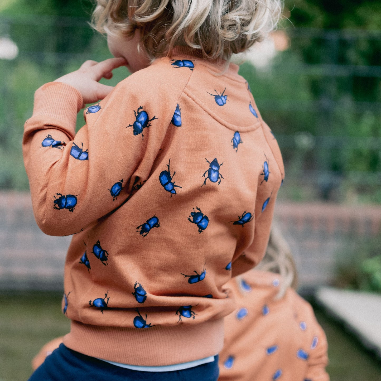 Boy wearing the bomber jacket. with the beetles collection fabric