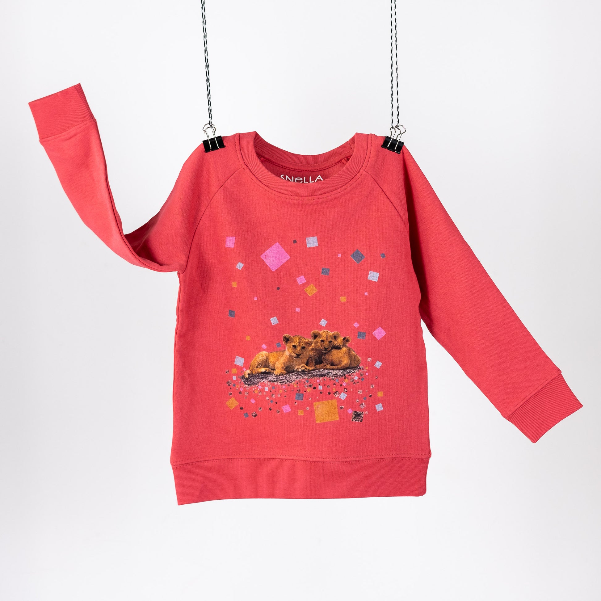Red terry children's sweatshirt with digital print featuring lion cubs and colourful squares. Logo screen printed in neck. Front view.
