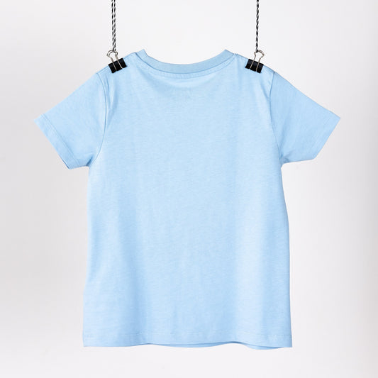 Light blue children's t-shirt with a digital print of blue irises and beetles. Hanging like a piece on art. Back view.