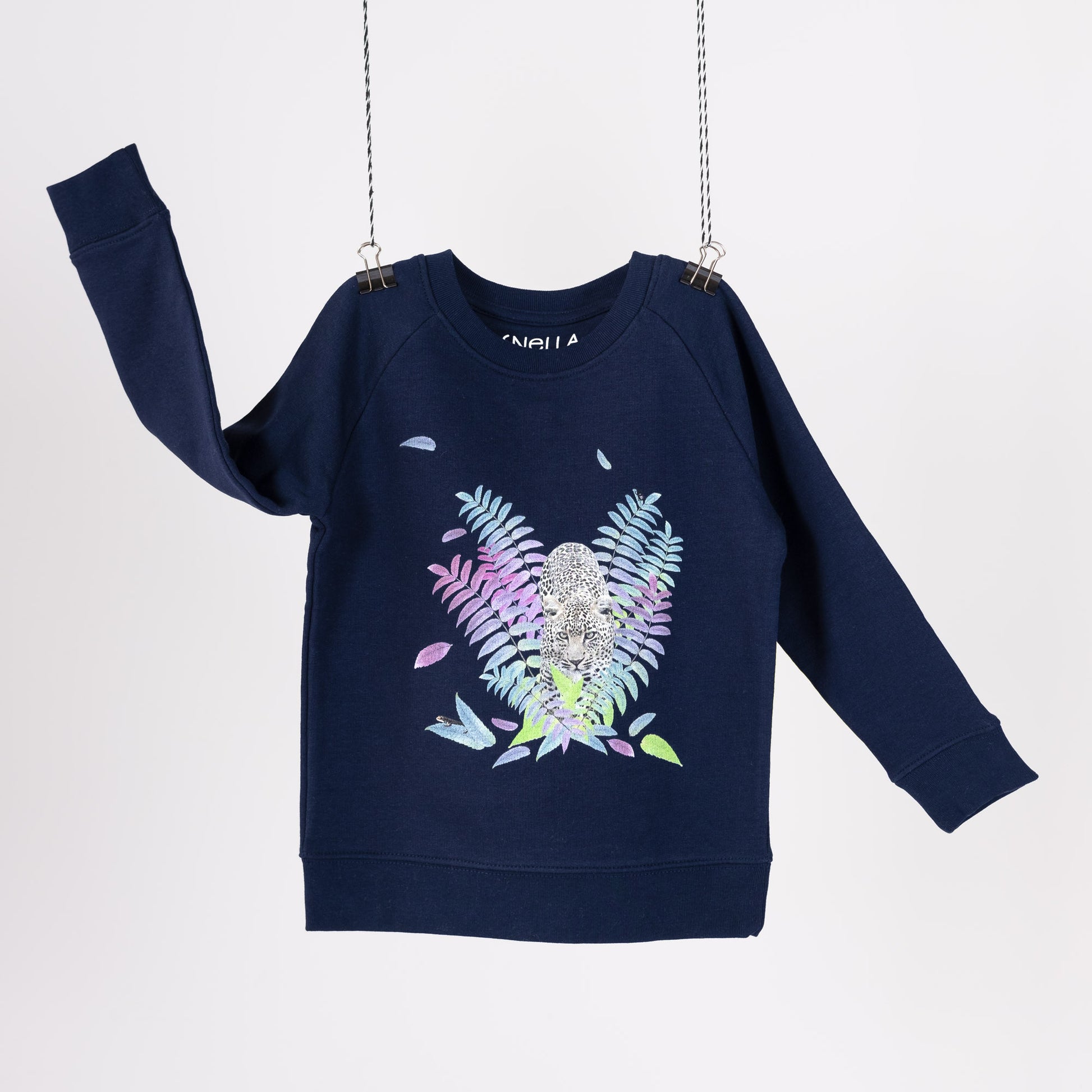 Navy blue terry children's sweatshirt featuring a digital print with a leopard and colourful foliage. Screen printed logo in the neck. Front view